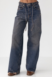 Жіночі джинси на зав'язках із потертостями Жіночі джинси на зав'язках із потертостями